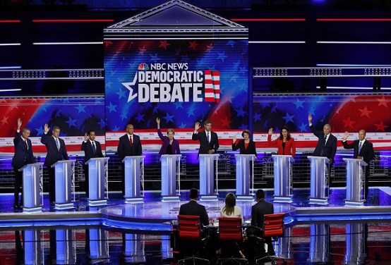 Candidates raise hands at the first U.S. 2020 presidential election Democratic candidates debate in Miami, Florida, U.S.,